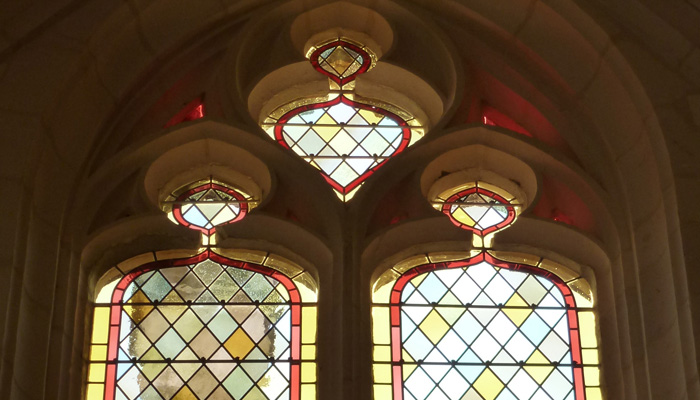 restauration de patrimoine dans une église reflets sur un mur des vitraux d'une église